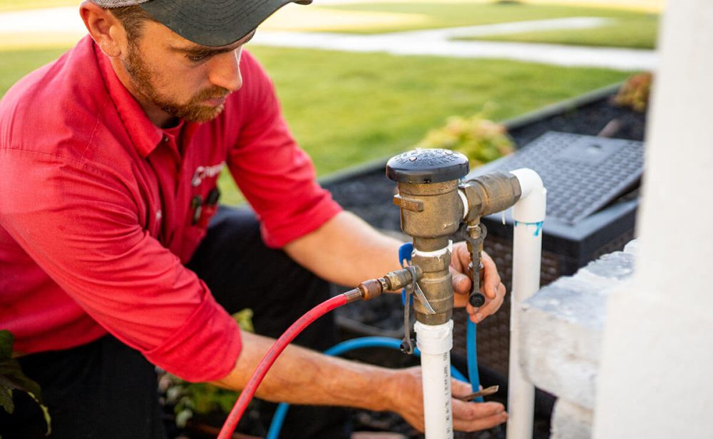 Sprinkler Technician Testing a Backflow  Device