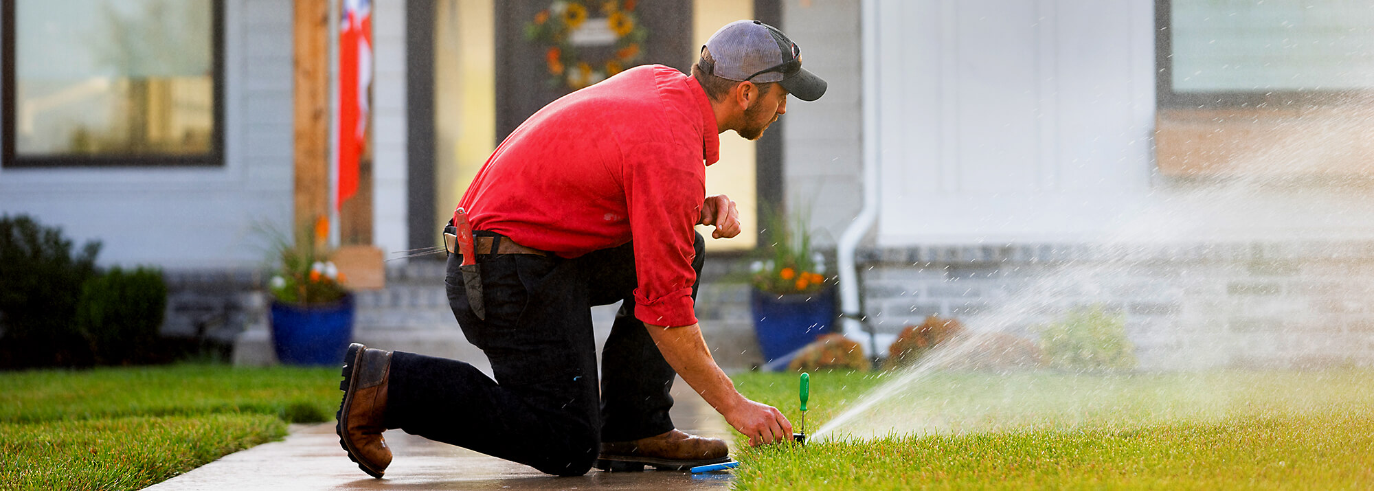 Reddi Technician Repairing Water Sprinkler in Yard