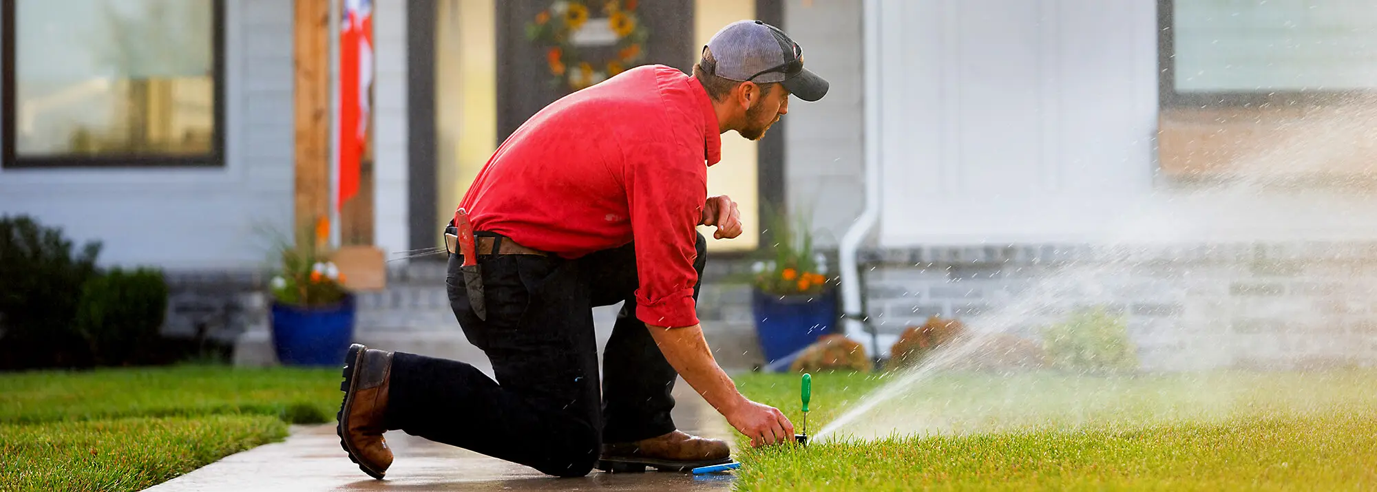 Sprinkler Tech Adjusting Watering Distance on Lawn
